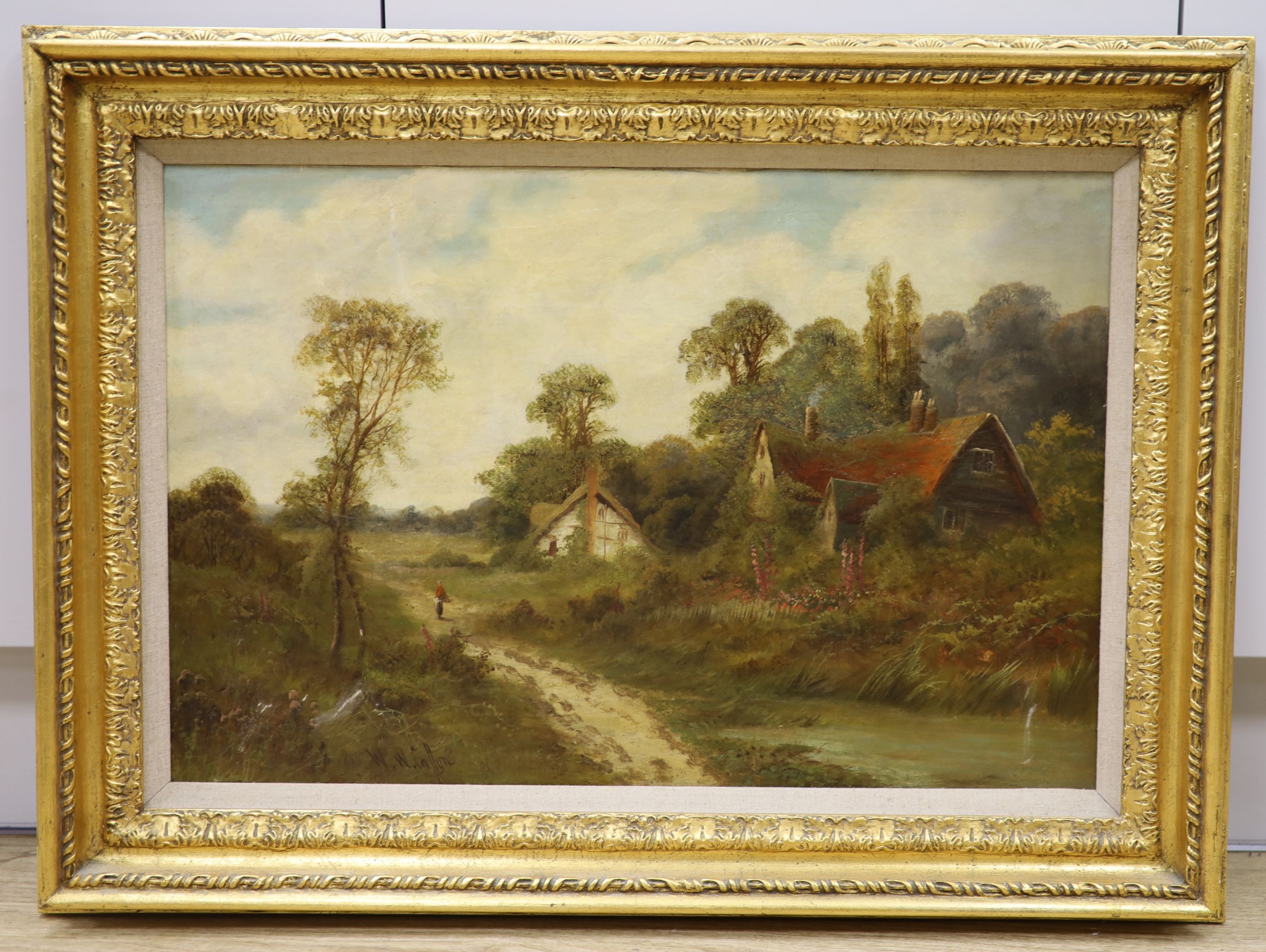 Walter Wallor Caffyn (1845-1898), oil on canvas, Woman with faggots passing a cottage, signed, 40 x 60cm.